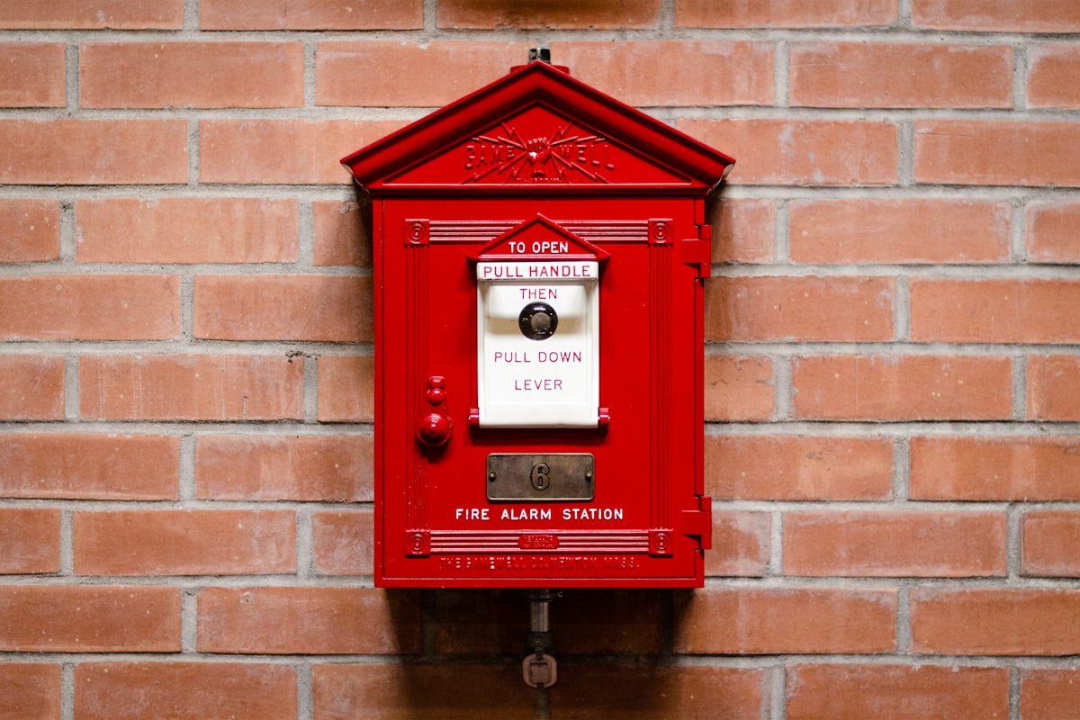 Classic red fire alarm pull station mounted on a wall
